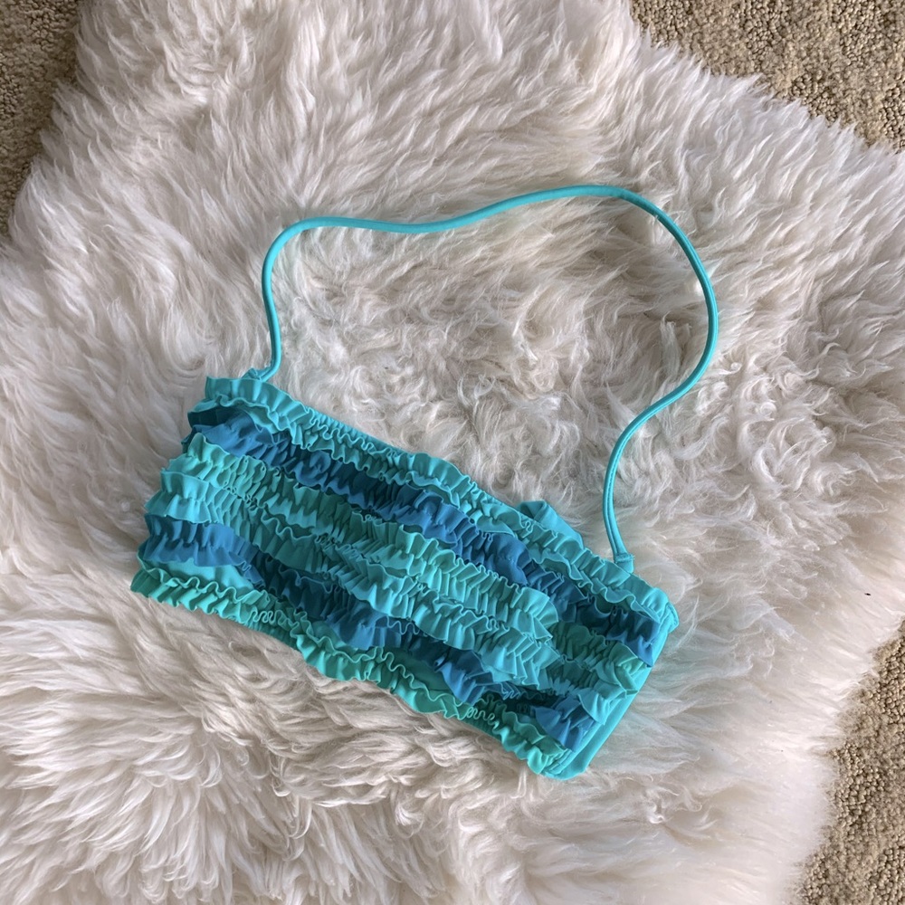 Bikini top by Victoria’s Secret.